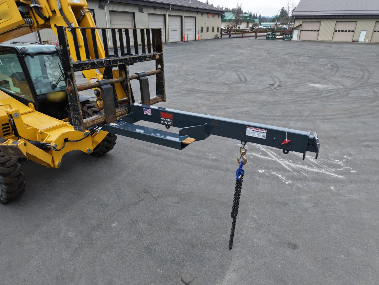 IA-JB-60T telescoping jib boom mounted in a telehandler fork carriage with load chart and labels visible