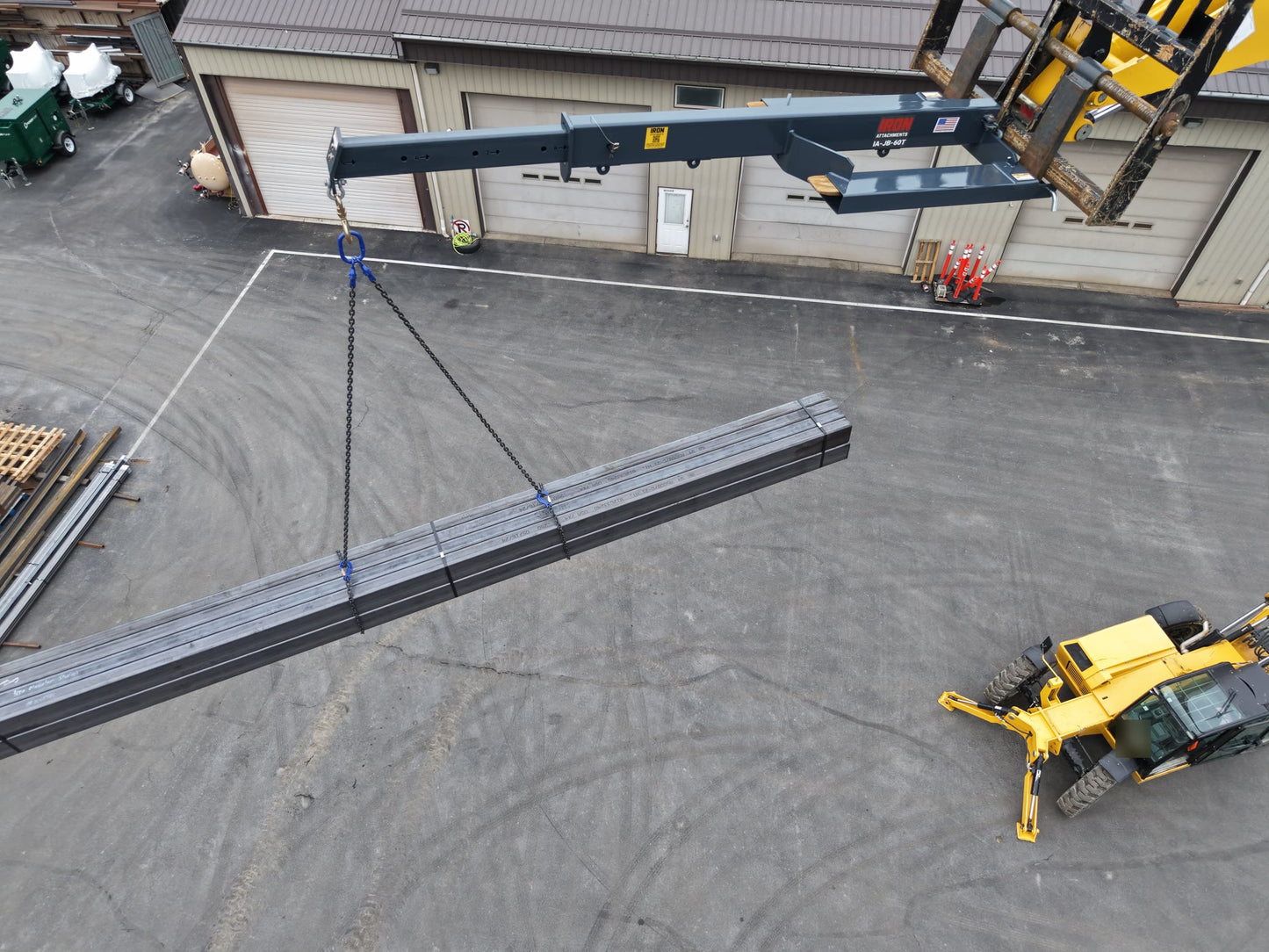 IA-JB-60T jib boom extended at height carrying a long steel bundle level on a chain bridle