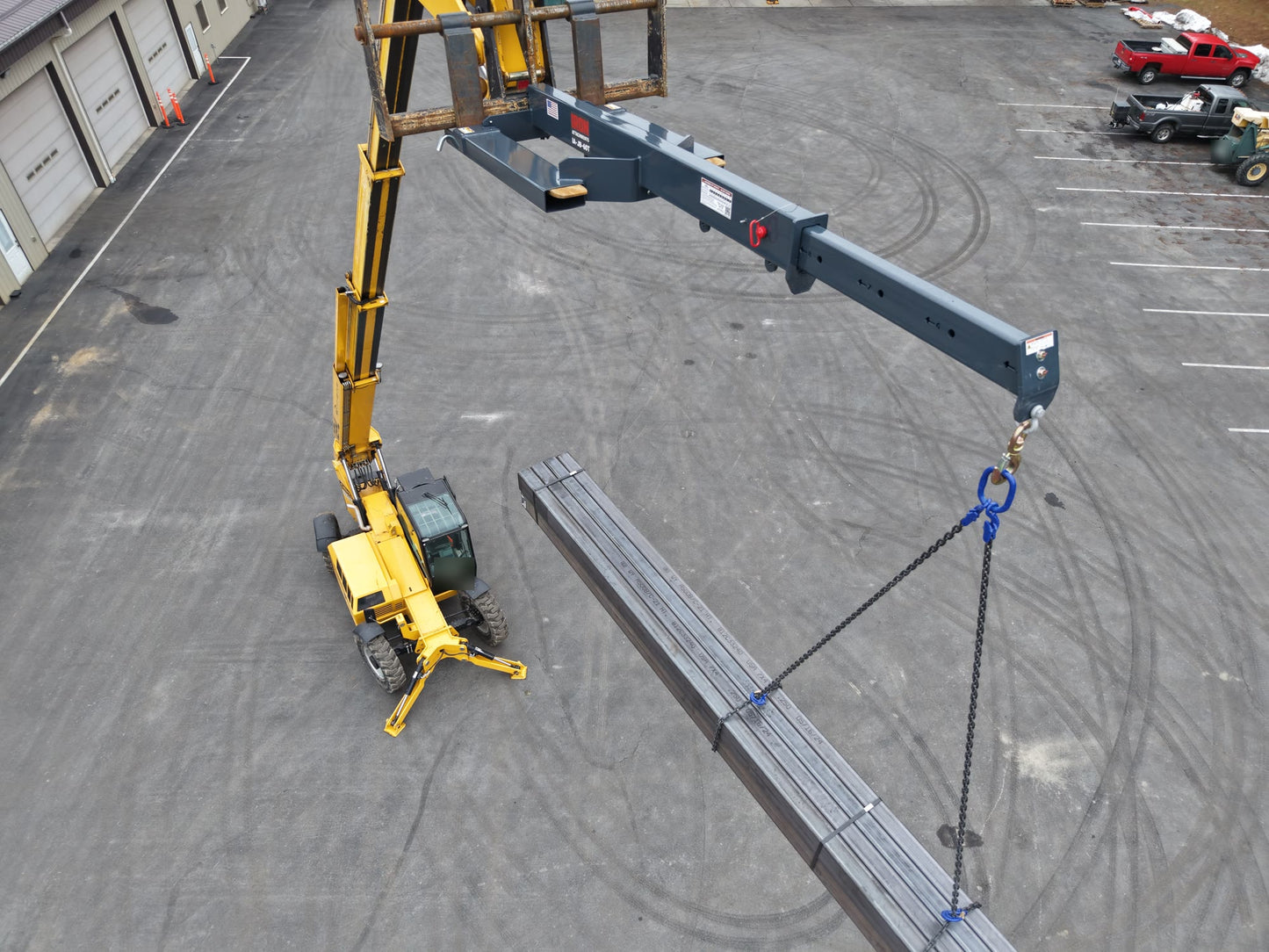 Telehandler lifting a steel load with the IA-JB-60T jib boom extended